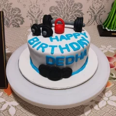 A Gym Lover Fondant Cake adorned with intricate gym-related designs and vibrant colors, available for delivery in Noida, East Delhi, and Ghaziabad.