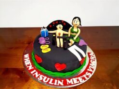 Bold & Playful Couple Theme Cake with black fondant base, handcrafted couple figurines and red heart accents by Lallantop Cake Shop