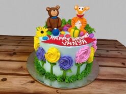 Bouncy Tiger and Bear Party Cake with colorful fondant flowers and figurines from Lallantop Cake Shop.
