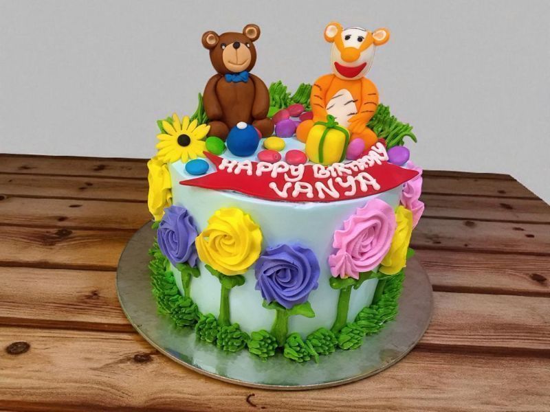 Bouncy Tiger and Bear Party Cake 3 Bouncy Tiger and Bear Party Cake with colorful fondant flowers and figurines from Lallantop Cake Shop.