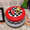 Car Race Designer Fondant Cake 2 Car Race Designer Fondant Cake 2.5 kg with red and yellow race cars and chequered racing design
