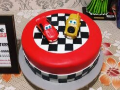 Car Race Designer Fondant Cake 2.5 kg with red and yellow race cars and chequered racing design