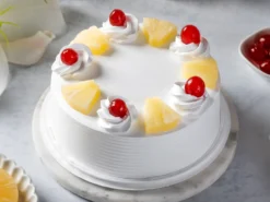 Fresh Pineapple Regular Cake with pineapple chunks and cherries at LallanTop Cake Shop for delivery in Noida, Ghaziabad, East Delhi, and South East Delhi