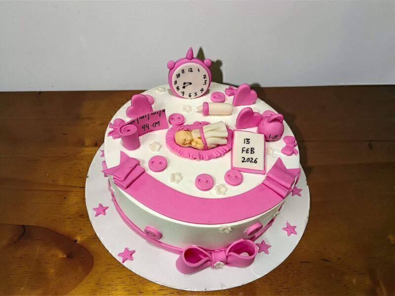 Welcome Baby Girl Celebration Cake 3 Welcome Baby Girl Celebration Cake with pink fondant design and sleeping baby topper by Lallantop Cake Shop
